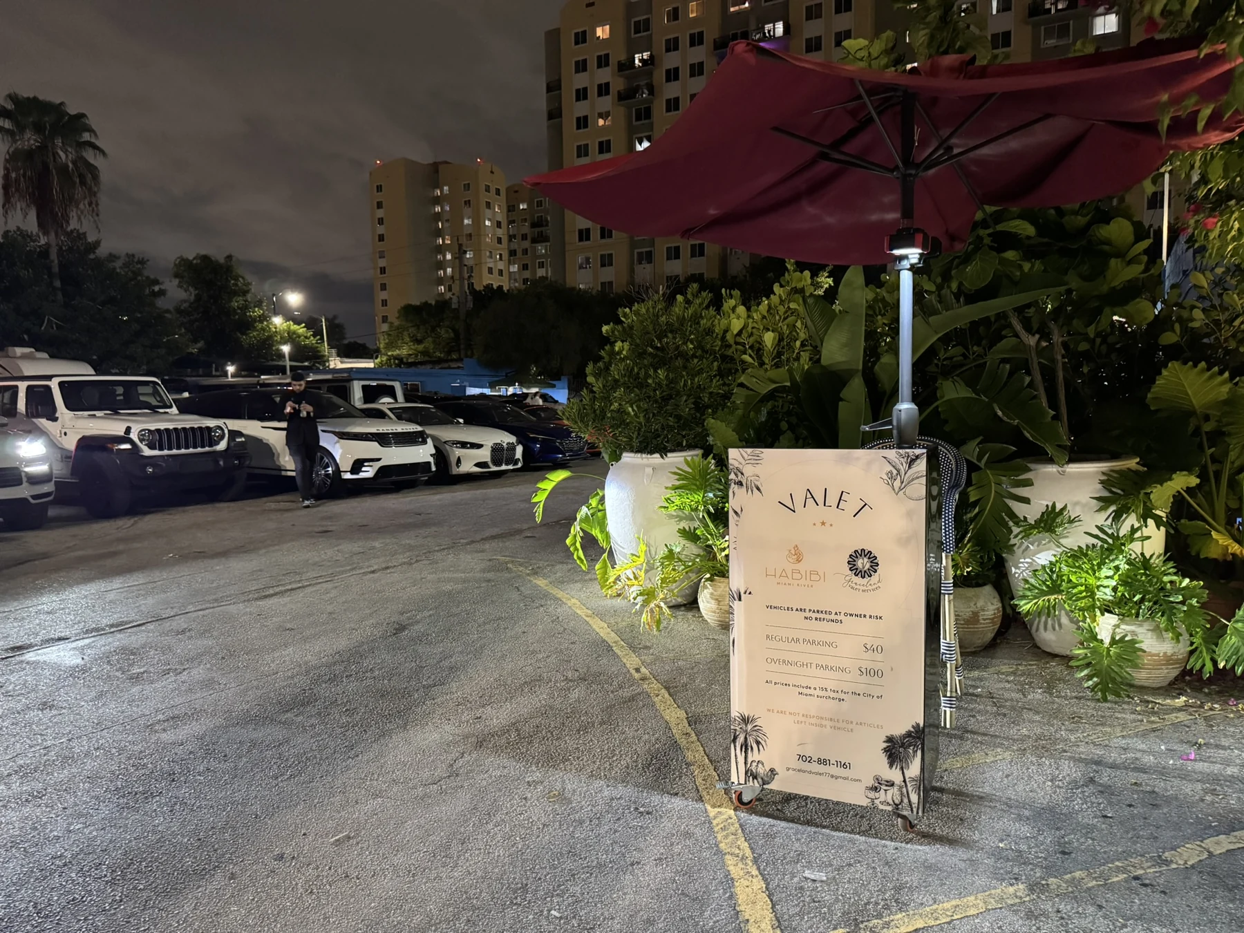 Graceland's valet stand and parked vehicles at Habibi on the River